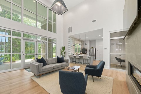 A modern living room with a grey sofa and a grey armchair.