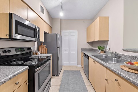 A kitchen with a black stove top oven and a black refrigerator.
