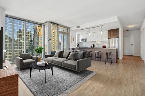 A modern living room with a grey sofa and a black coffee table.