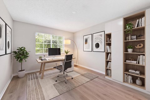 A room with a desk, chair, and a bookshelf.