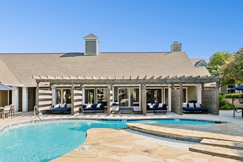 A house with a pool in front.