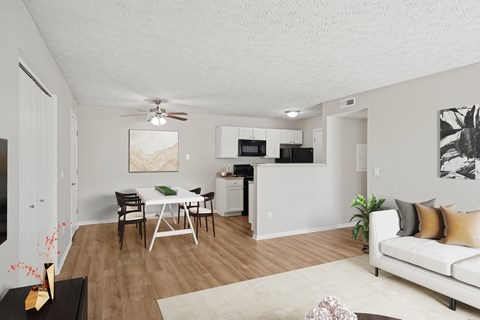A living room with a white couch and a dining table.