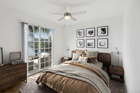 A bedroom with a bed, nightstand, and a ceiling fan.