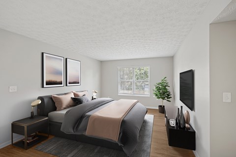 A bedroom with a large bed and a flat screen TV mounted on the wall.