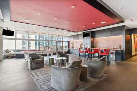A modern living room with a red ceiling and grey walls.