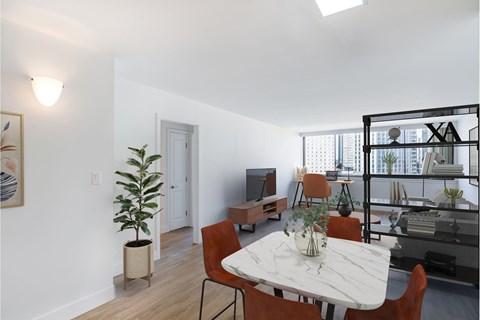 A dining room with a white table and chairs.
