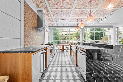 a large kitchen with marble counter tops and a large window