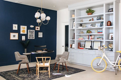 A dining area with a table, chairs, and a bicycle.