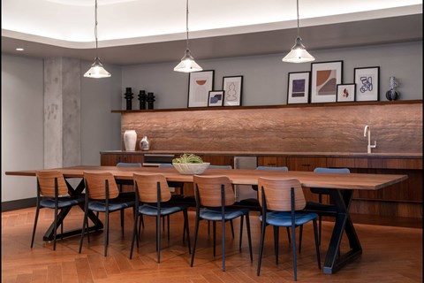 A modern dining room with a wooden table and chairs.