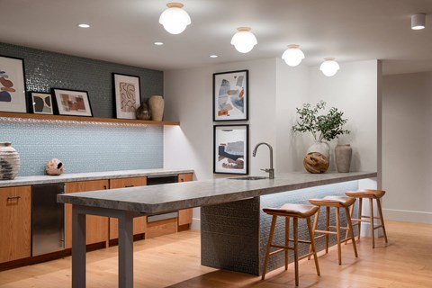 A kitchen with a table and chairs.