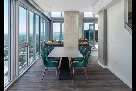 A modern dining room with a large table and chairs.