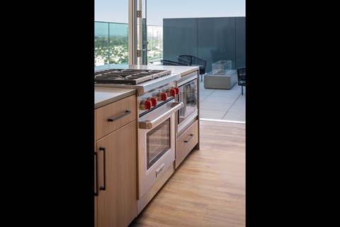 A modern kitchen with wooden cabinets and stainless steel appliances.
