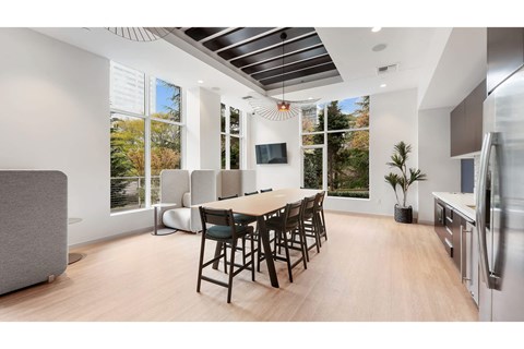 A modern kitchen with a dining table and chairs.