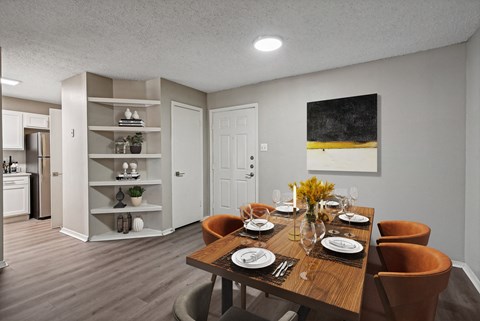 a dining room with a wooden table and chairs