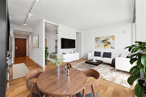 A modern living room with a wooden table and chairs.