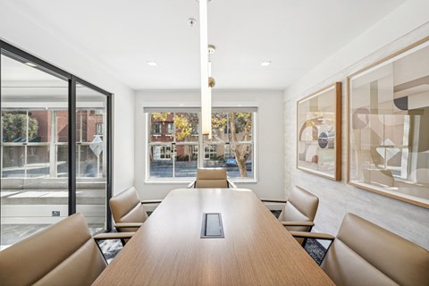 a conference room with a long wooden table and chairs
