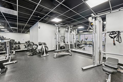 A spacious gym with a variety of equipment.