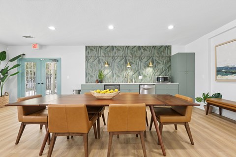 A dining room with a table and chairs.