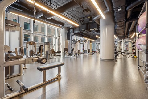 a gym with weights and other exercise equipment in a building