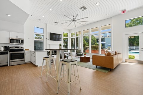 A modern kitchen with a bar stool in the middle.