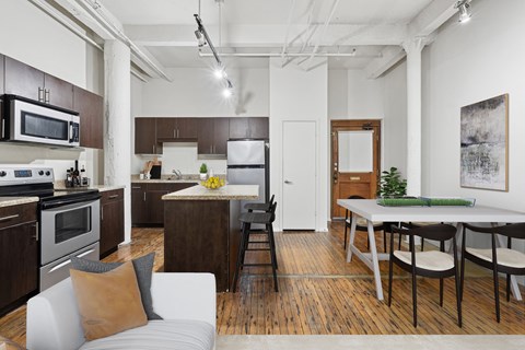 A modern kitchen with a dining table and chairs.