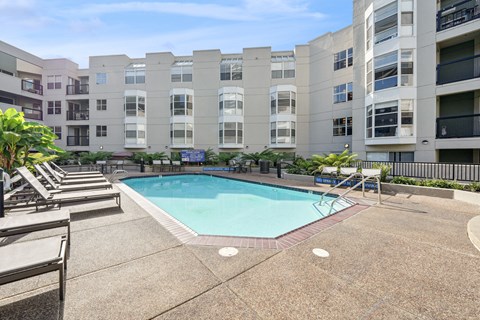 a swimming pool in front of an apartment building