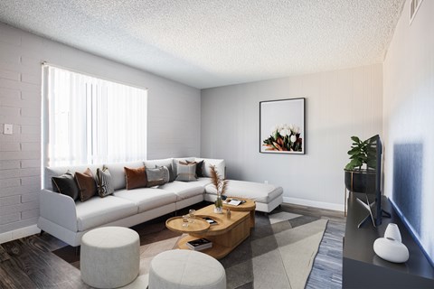 A living room with a white couch, a coffee table, and a painting on the wall.
