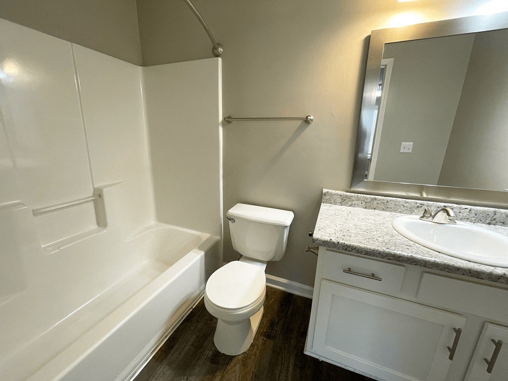 a bathroom with a sink toilet and bath tub