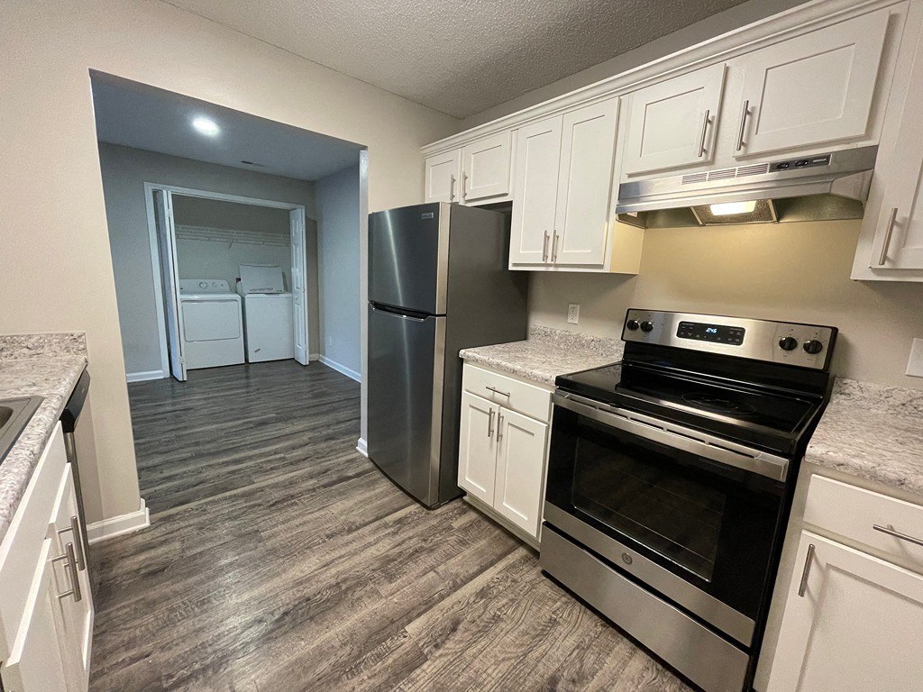 a kitchen with stainless steel appliances and white cabinets