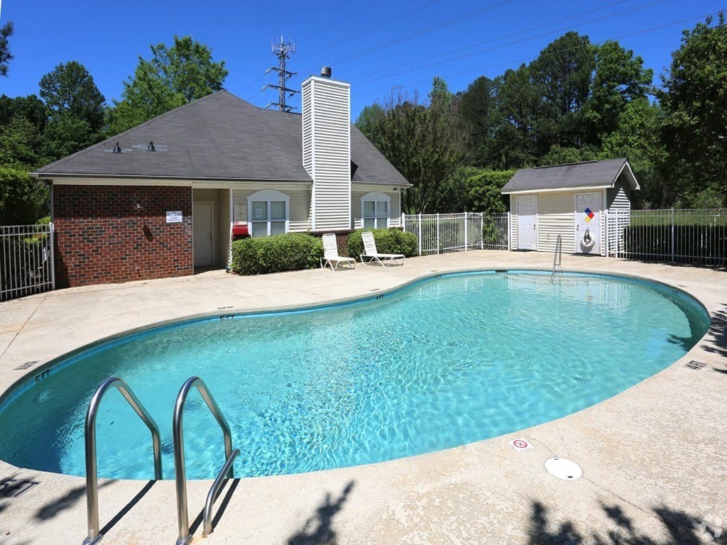 a pool with a house in the background