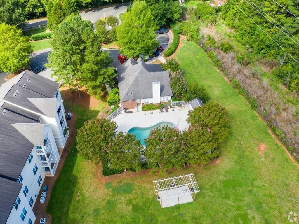 a birds eye view of a house with a yard and a pool