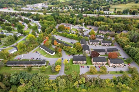 A bird's eye view of a residential area with houses and trees.