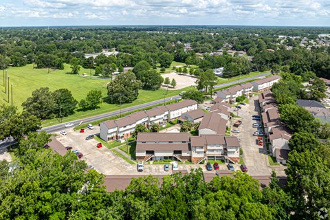 A bird's eye view of a residential area with houses and cars.