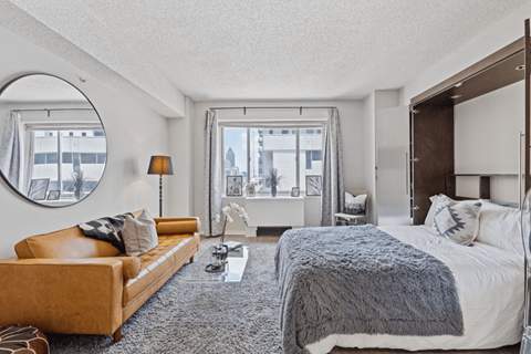 A bedroom with a large bed and a couch.
