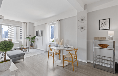 A modern dining room with a wooden table and chairs.