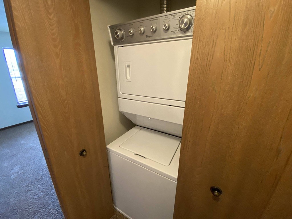 a washer and dryer in a room with a wooden door