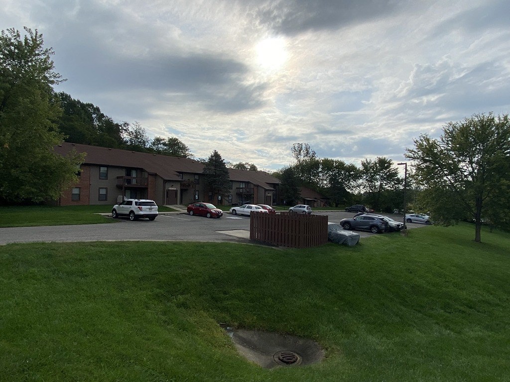 a parking lot with cars in front of a building