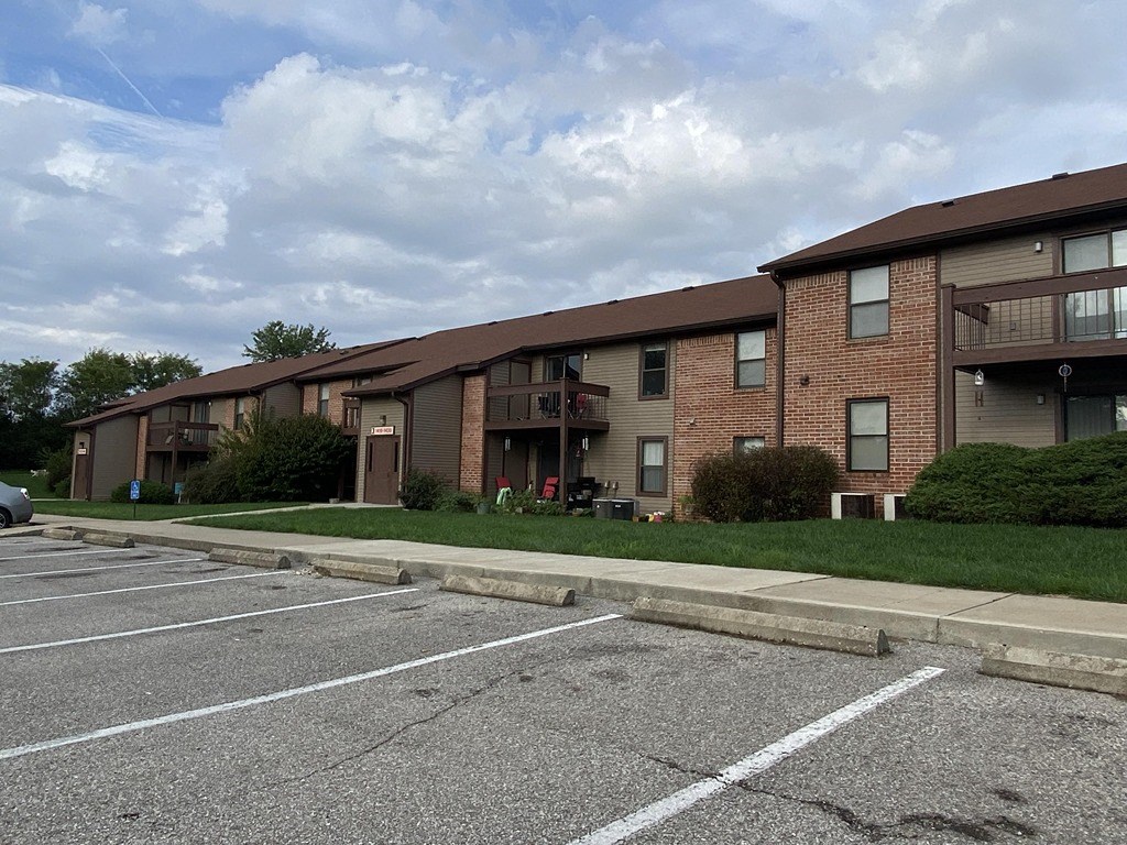 a parking lot in front of an apartment building