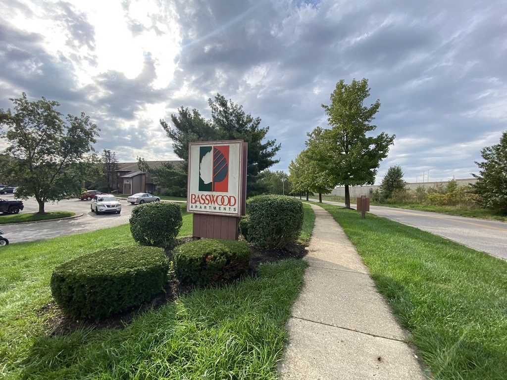 a sign for a gas station on the side of a sidewalk
