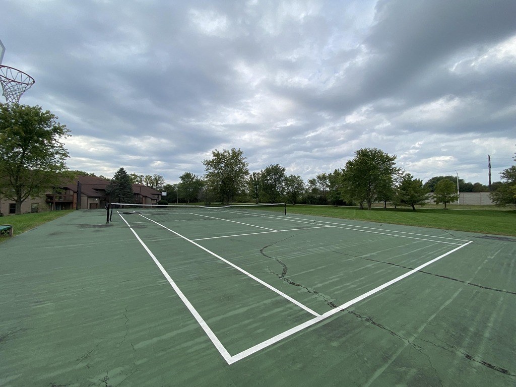 a tennis court at the commons on a cloudy day
