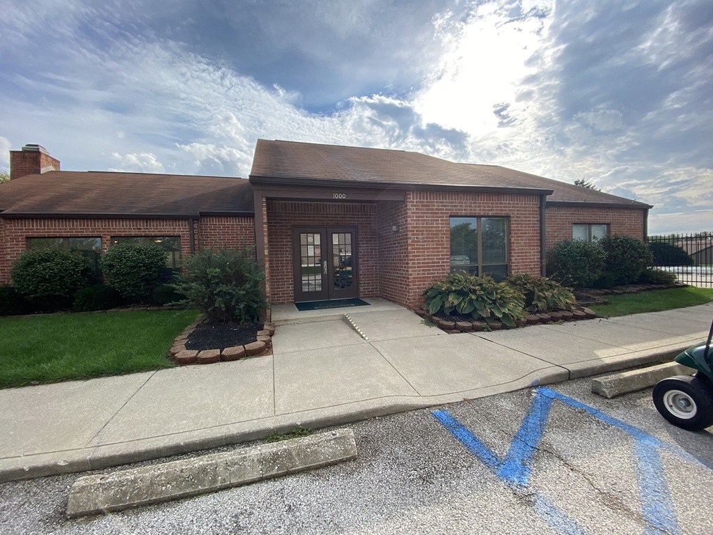 a house with blue tape on the sidewalk in front of it
