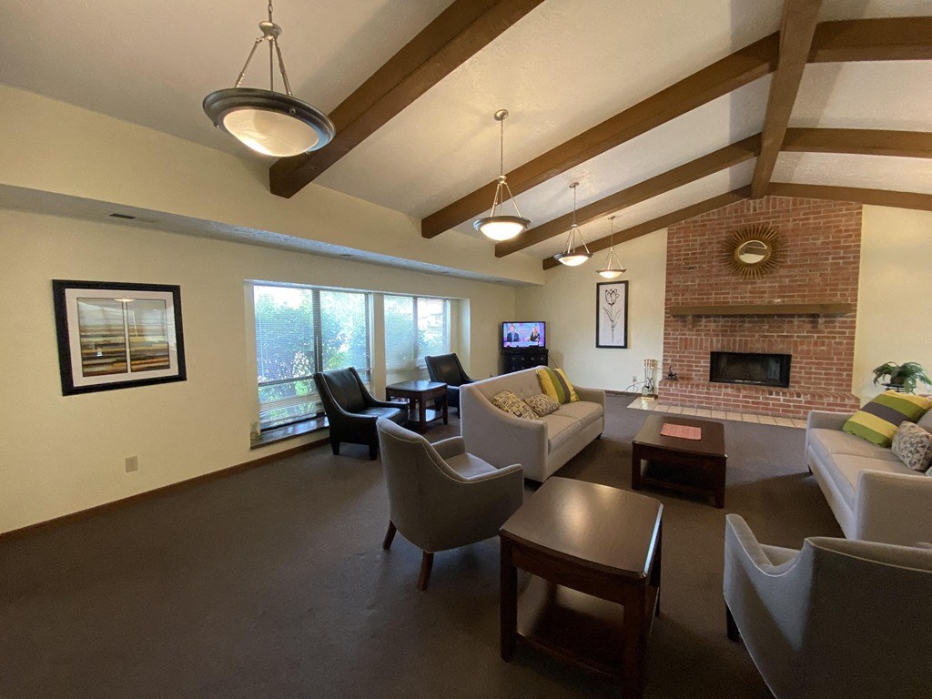 a living room with couches and chairs and a fireplace
