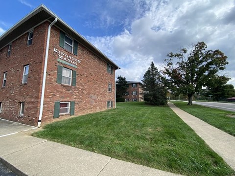 a red brick building on the side of a sidewalk