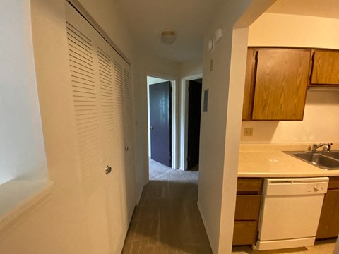 a kitchen with a sink and a door to a hallway