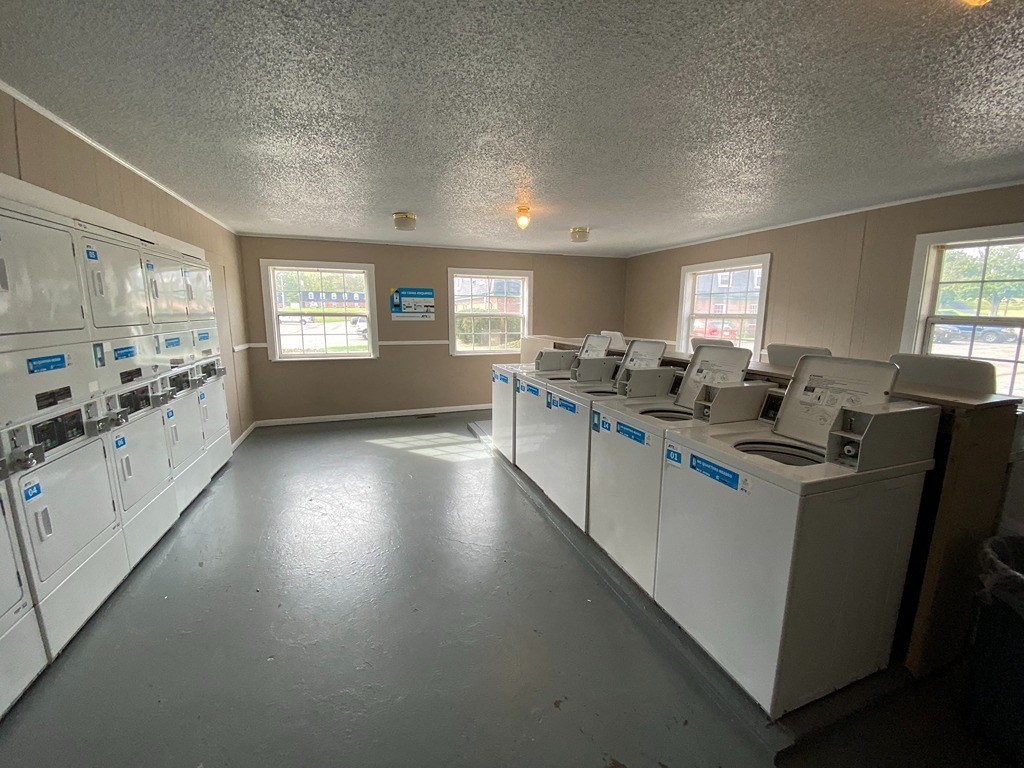 the laundry room has many washes and dryers in it