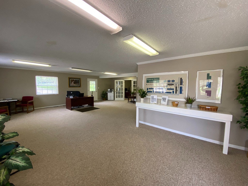 a large room with a white counter in the middle