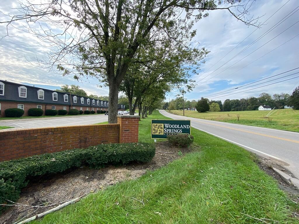 a sign on the side of a road in front of a building