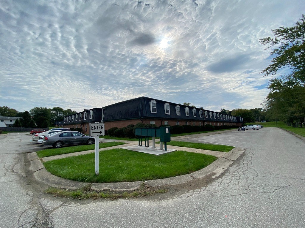 a long building with a parking lot in front of it