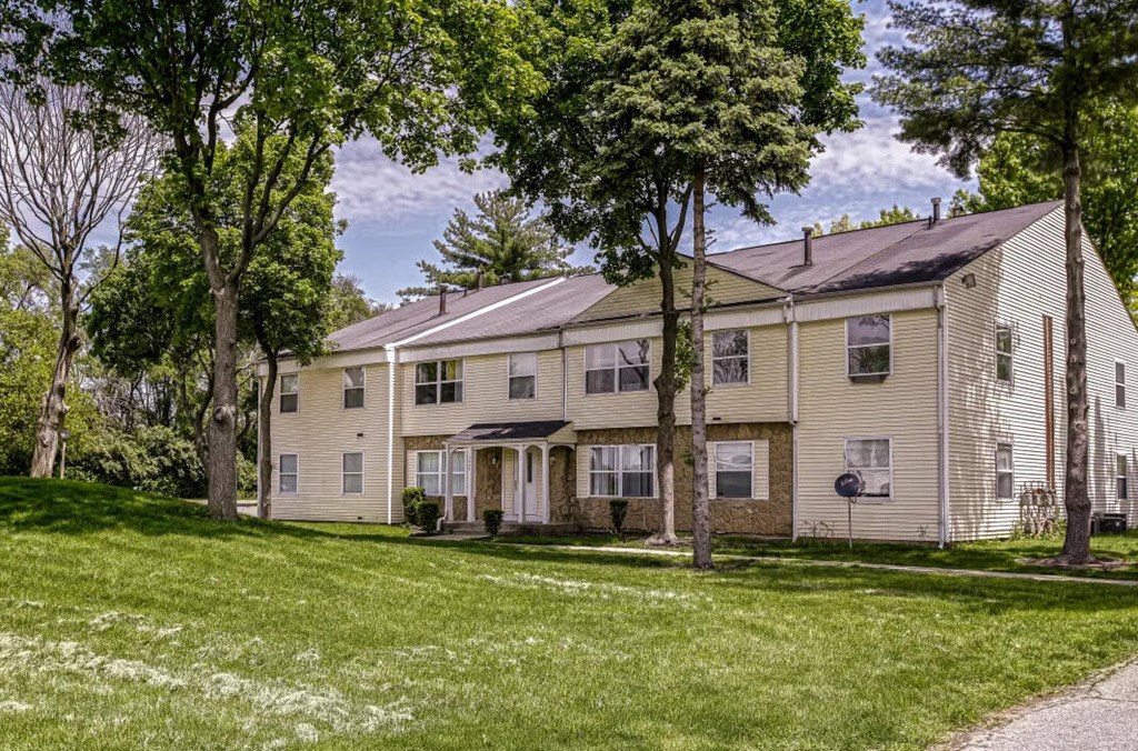 a large house with a yard and trees