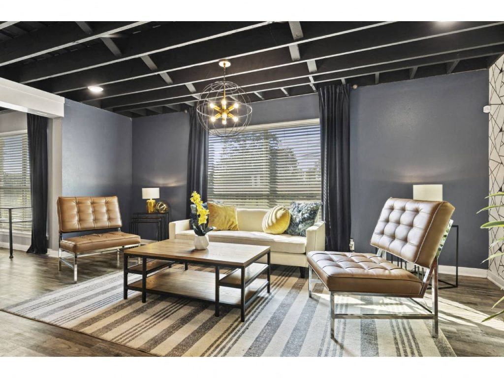 a living room with leather furniture and a large window